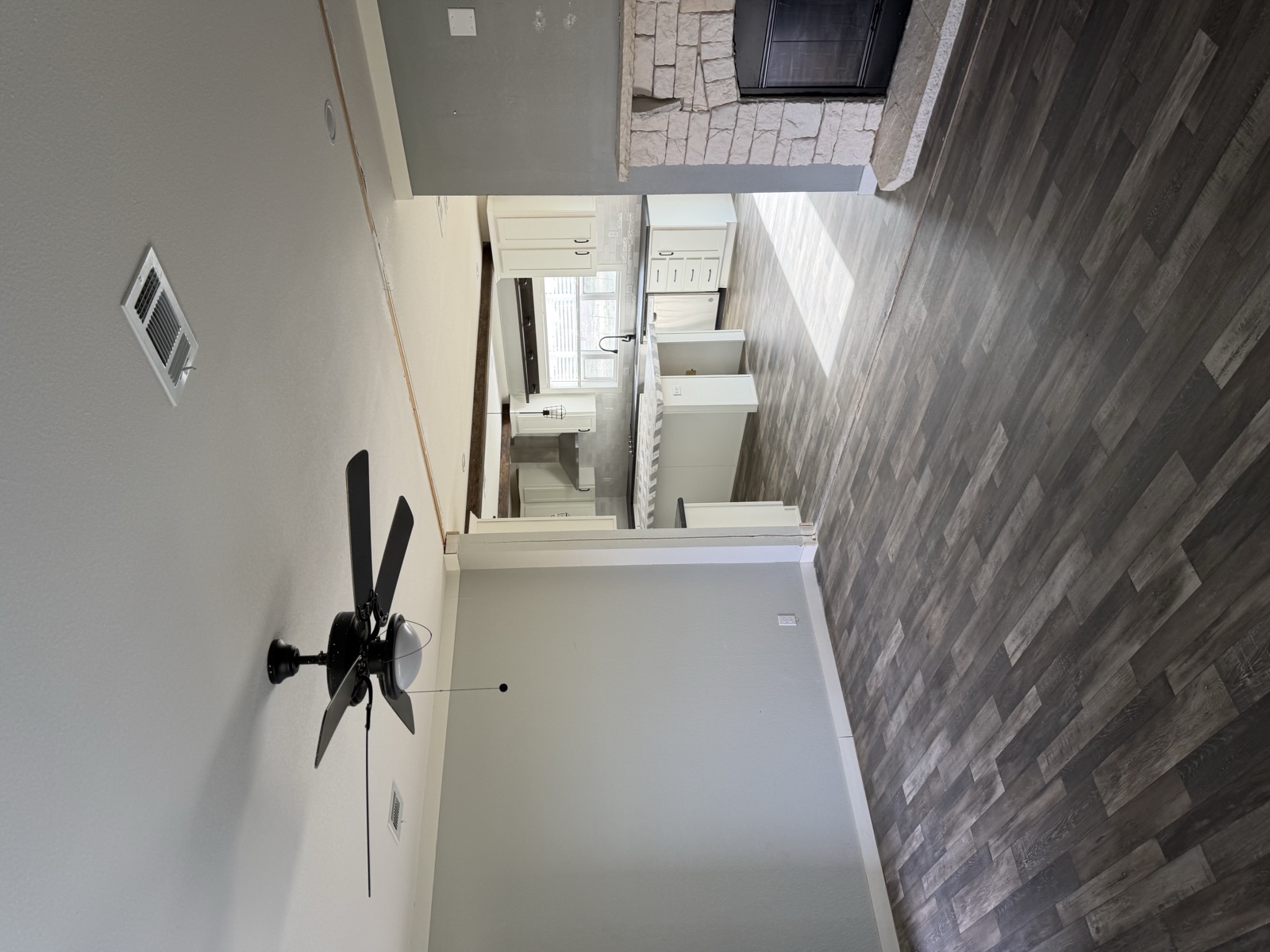 Living area with fireplace and ceiling fan