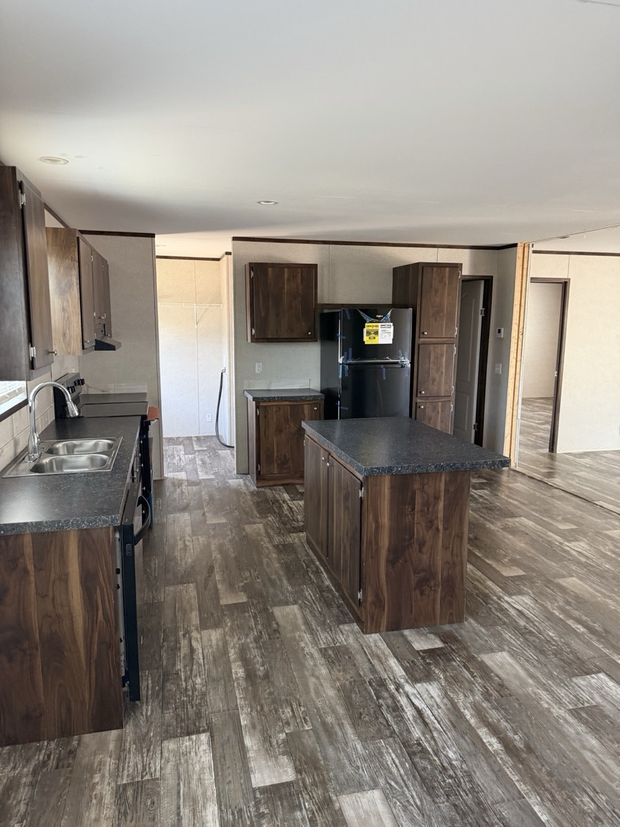 2023 Champion 30×60 — Kitchen island, appliances and utility area