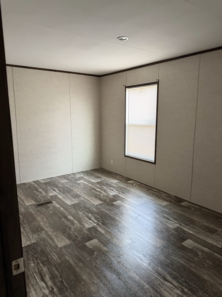 2023 Champion 30×60 — Bedroom with wood-look flooring