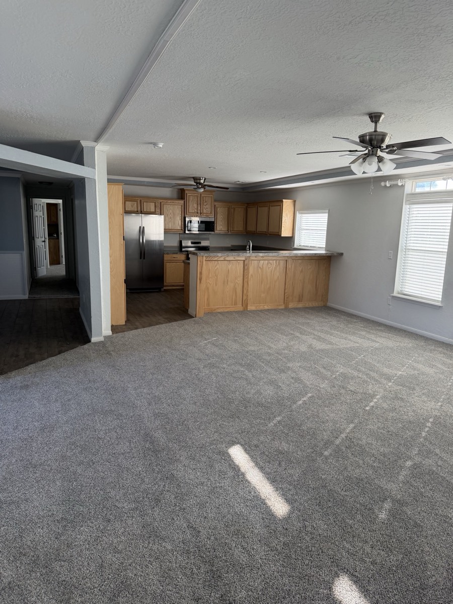 2023 Deming Solitaire 32×82 — Open living area and kitchen
