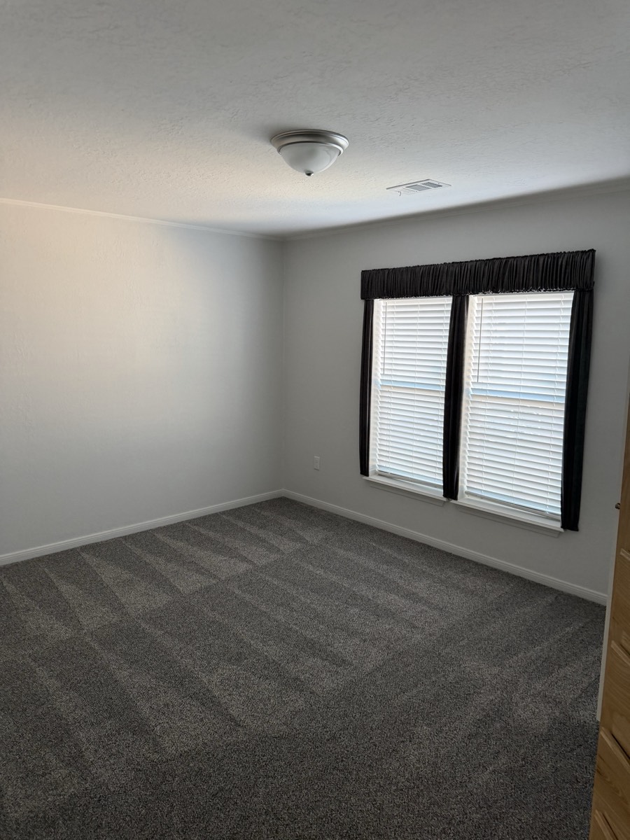 2023 Deming Solitaire 32×82 — Bedroom with window treatments