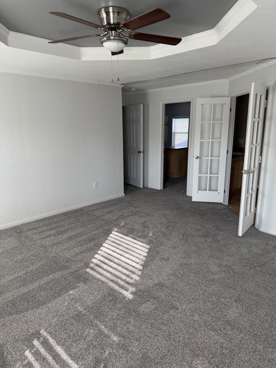 2023 Deming Solitaire 32×82 — Primary bedroom and French doors