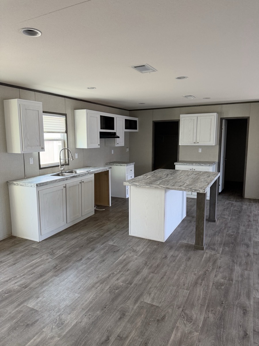 2025 Jessup Panama 28×56 — Island kitchen with white cabinetry